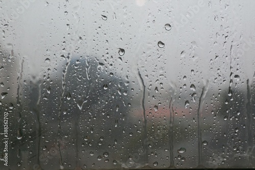 Rain drops on the window in rainy day. View from building.  Nature background concept.