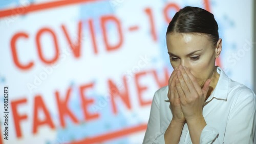 Beautiful girl coughs and sneezes, gets the latest information on the epidemic when she finishes the pandemic and lockdown, covid 19 fake news