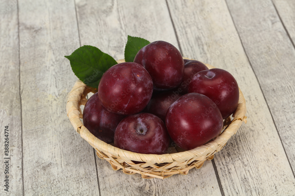 Plum heap in the wooden basket Plum heap in the wooden basket