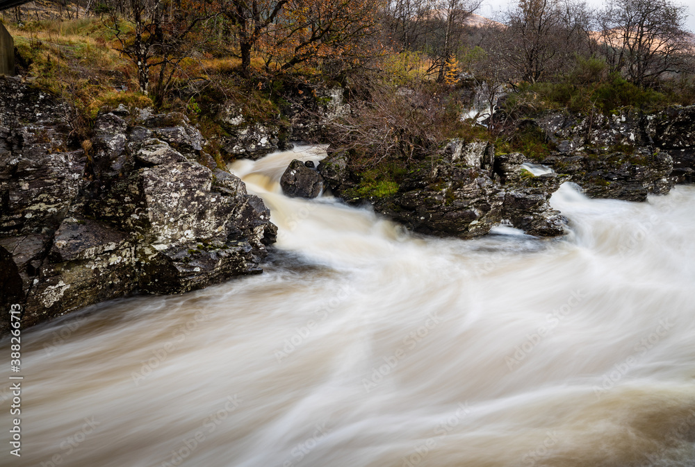 long exposure shot of the waterfalls in glen orchy near bridge of orchy in the argyll region of the highlands of scotland during autumn long exposure shot of the waterfalls in glen orchy near bridge of orchy in the argyll region of the highlands of scotland during autumn