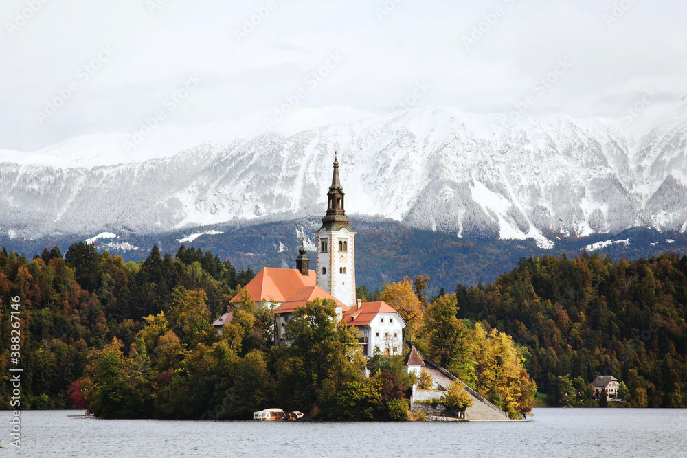 Scenic View of the snow-capped Alps mountain peaks against the backdrop of lake Bled.