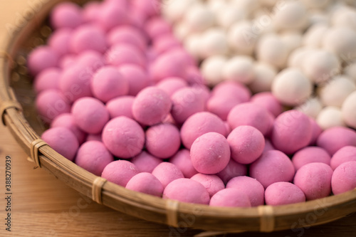 Raw little tangyuan in a sieve over wooden table. © RomixImage