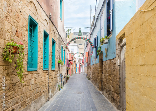 Small alleyway with colorful houses, Christian quarter in the Mediterranean coastal town Tyre, Lebanon photo
