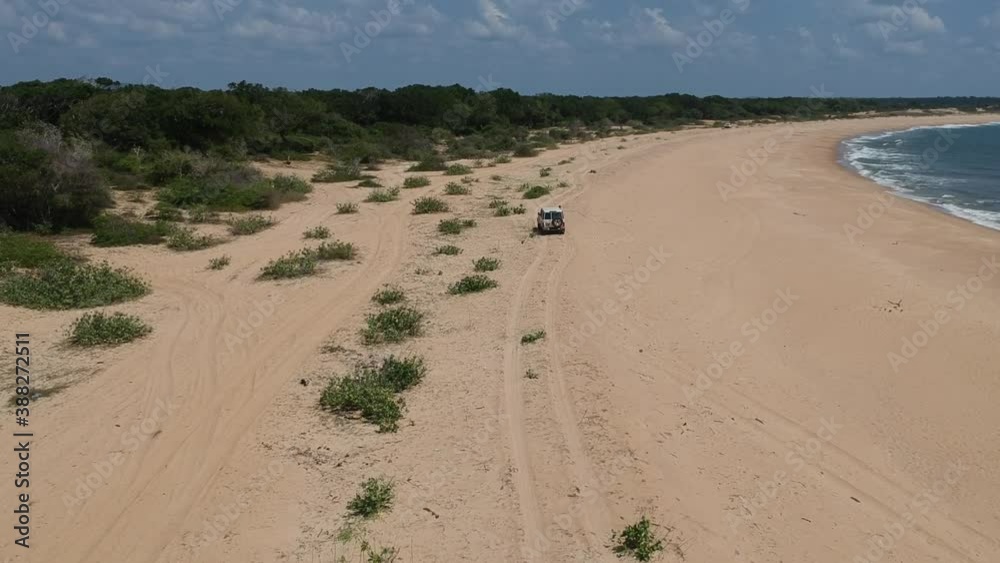 Aerial Over Beach Coastline At Edge Of Yala National Park In Sri Lanka With 4x4 Driving Off Aerial Over Beach Coastline At Edge Of Yala National Park In Sri Lanka With 4x4 Driving Off