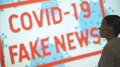 A beautiful girl looks at the screen, gets the latest information about the epidemic when she finishes the pandemic and lockdown, covid 19 fake news