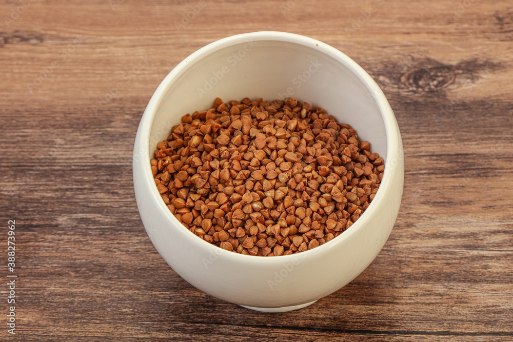 Raw buсkwheat cereal in the bowl Raw buсkwheat cereal in the bowl