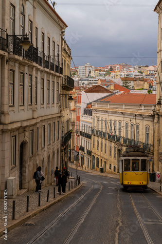  Yellow tram circulating in a Lisbon street