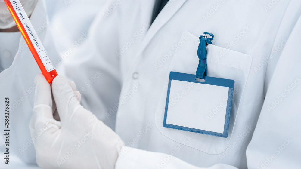 image of a scientist looking at a tube with a test .