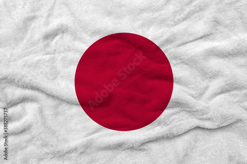 National flag of Japan on fabric texture.