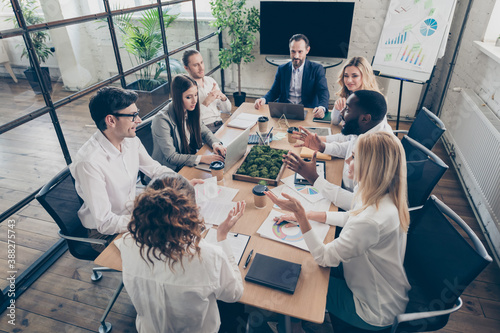 Top above high angle view photo of business people freelancers man woman sit table analyze cost economy reduction recession development strategy in workplace workstation