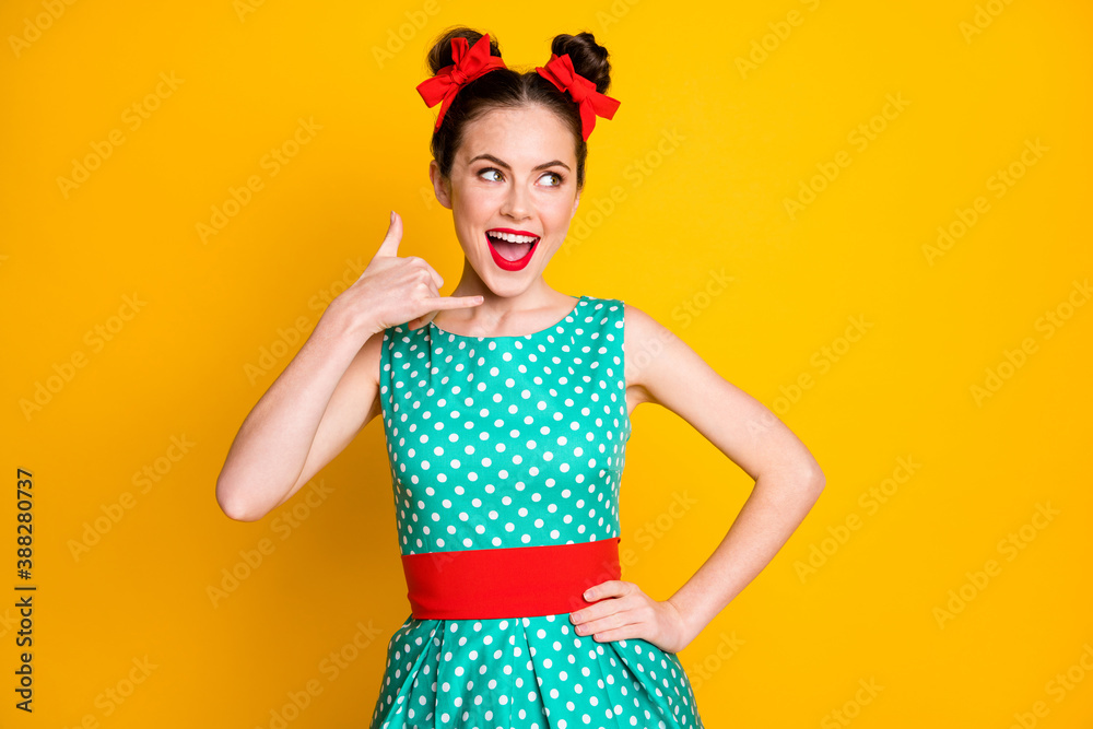 Portrait of nice charming cheerful cheery girl pretending to call phone isolated over vibrant yellow color background