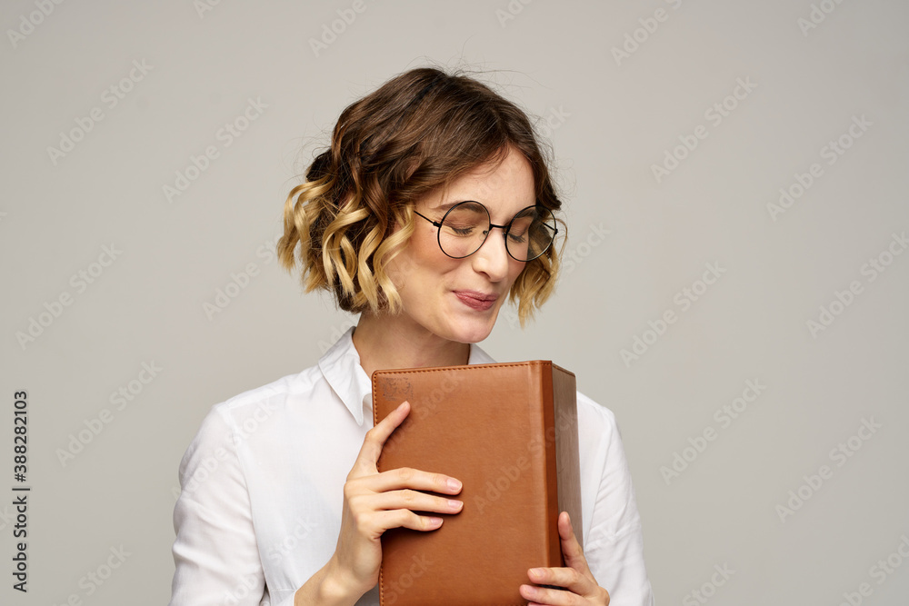 woman with notepad in hands business work beige background glasses hairstyle woman with notepad in hands business work beige background glasses hairstyle