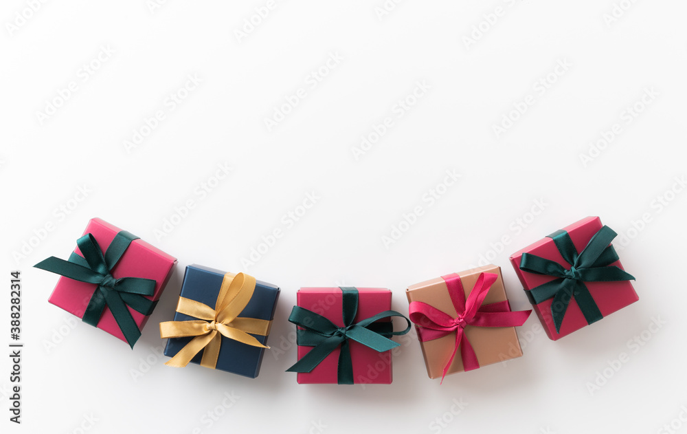 Fototapeta premium Top view many gift box on the white table. Copy space New year's and Christmas Day concept.