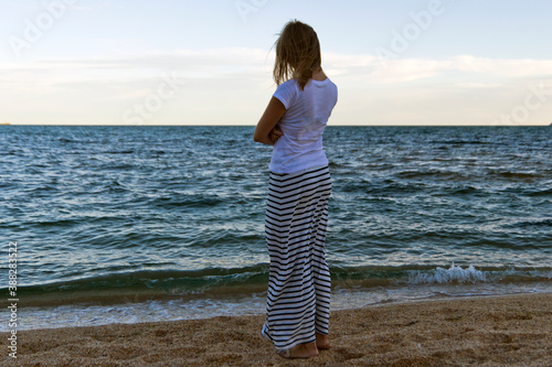 girl in a long skirt by the sea