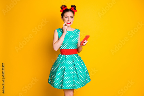 What if i get horrible feedback. Scared girl use smartphone wear teal clothes isolated bright color background