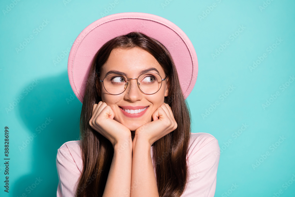 Photo of positive young girl touch fists cheeks look dreamy in empty space isolated over turquoise color background