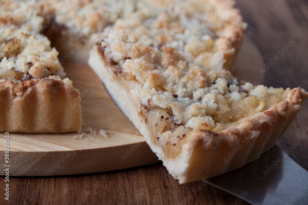 Piece of pie with streusel on a pie spatula Piece of pie with streusel on a pie spatula