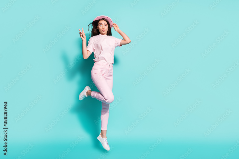 Full length body size view of her she nice attractive pretty cheerful girl jumping having fun pout lips showing v-sign isolated bright vivid shine vibrant green turquoise color background