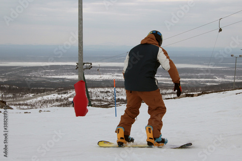 snowboarder rides downhill on the ski slope