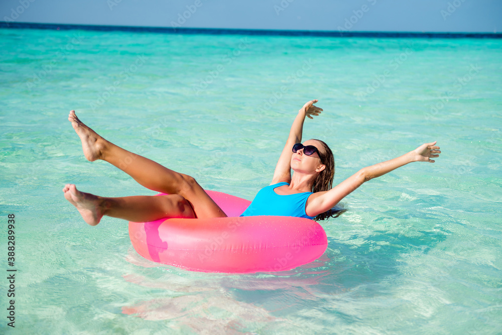 Portrait of her she nice attractive gorgeous fit slim dreamy healthy tanned girl lying on rubber circle floating enjoying sunny hot day wellness wellbeing vitality luxury resort spa