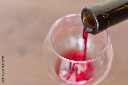the process of pouring red wine into a glass