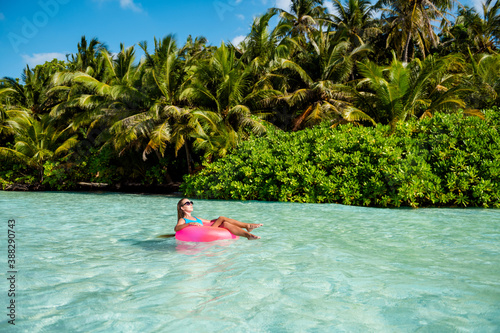 Full length photo of luxury dreamy lady tourist enjoy tropical resort relax swim lifebuoy azure water wear blue bikini bodysuit sunglass © deagreez