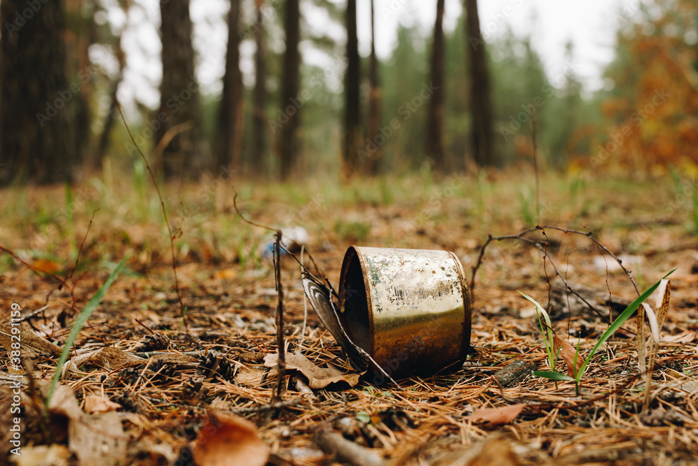Old rusty tin can on a ground in the forest