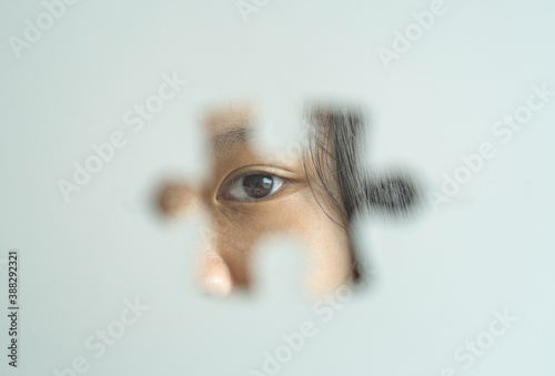 Schilderij op canvas Autism and autistic child eye background with jigsaw as a symbol foreground