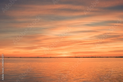 Beautiful sky in the city of Faro in Portugal. Colors of nature at sunset by the water. © SValeriia