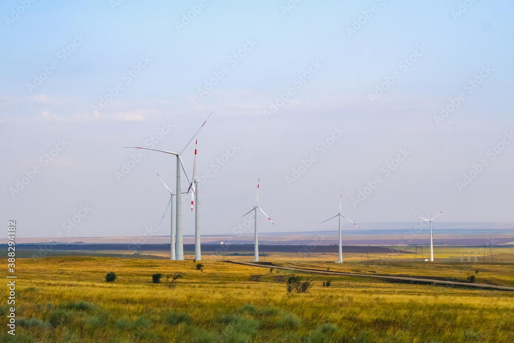 huge windmill generator turbines. Alternative energy.