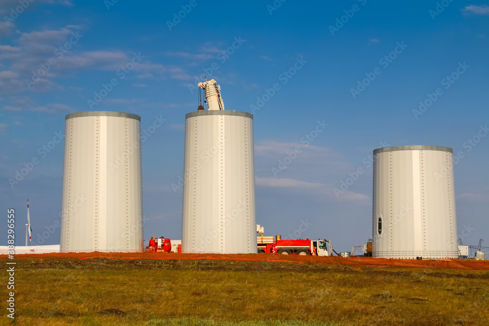 Windmill construction. Installation of wind turbine. Blue sky. Windmill construction. Installation of wind turbine. Blue sky.