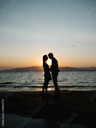 Couple silhouette sunset beach engagement