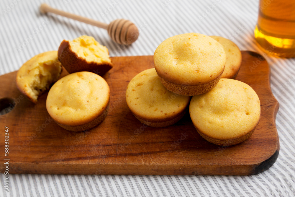 Homemade Cornbread Muffins on a rustic wooden board, side view. Close-up. Homemade Cornbread Muffins on a rustic wooden board, side view. Close-up.
