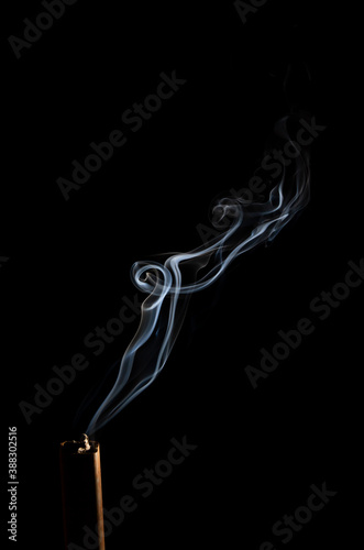 Smoke movement coming from incense stick on black background abstract smoke background on black background