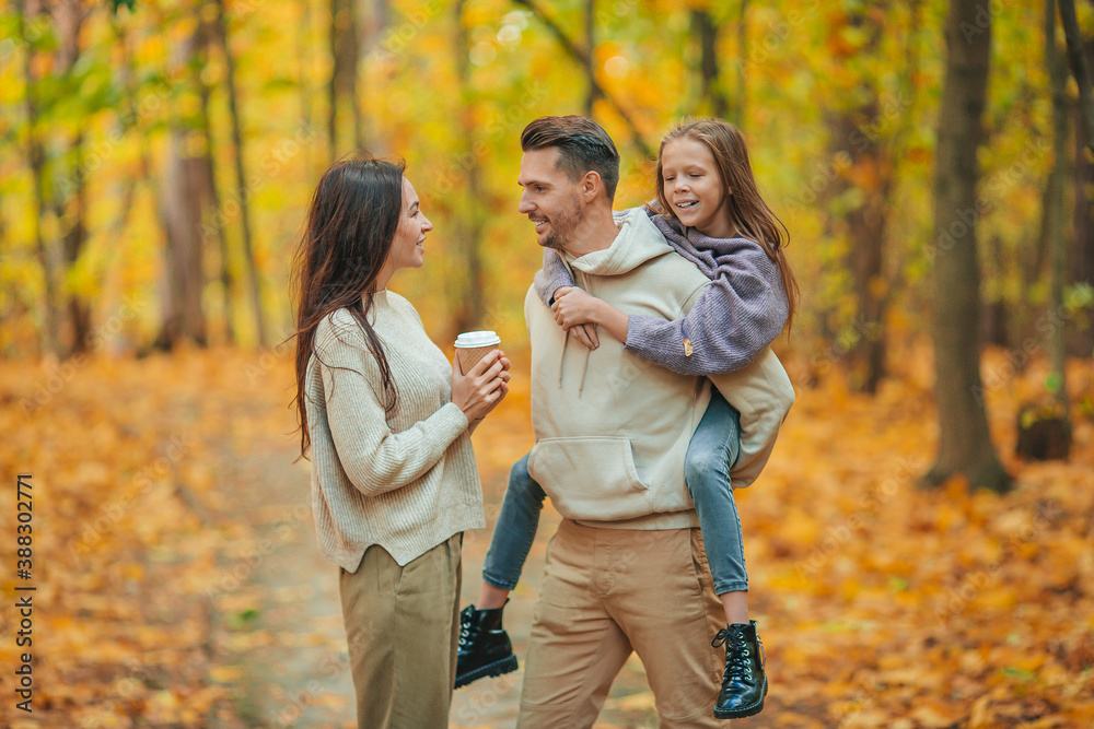 Portrait of happy family of three in autumn day Portrait of happy family of three in autumn day