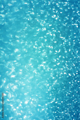 Blue glitter bokeh circle glow blurred and blur abstract. Glittering shimmer bright luxury . White and silver glisten twinkle for texture wallpaper and background backdrop. © wilawan
