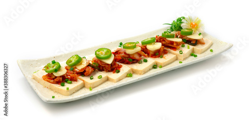 Tofu Kimchi Small Bite ontop Green Chili and Garlic decorate carved leek and spring onion