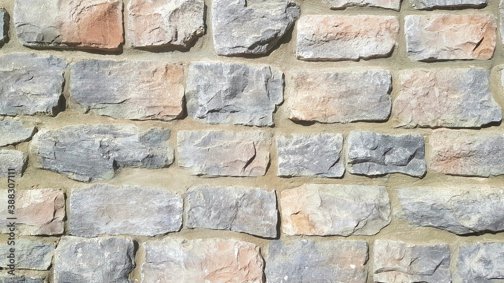 Fototapeta premium A Grey Stone Wall for Backgrounds, Backdrops, or Copy Space