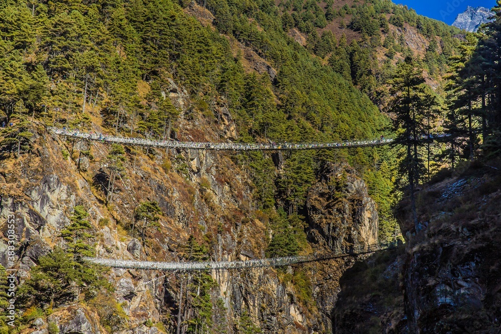 Fototapeta premium Great view of Hillary suspension bridge over the Dudh Koshi River between Jorsale and Namche Bazar on the way to Everest base camp. Nepalese Himalaya.