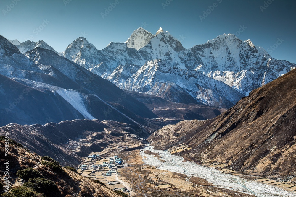 Great view of mountain river valley and mountain wall on the background. Cloudless sky. Nepal Himalaya.