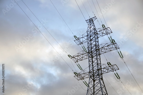 Power line mast against a gloomy gray sky.