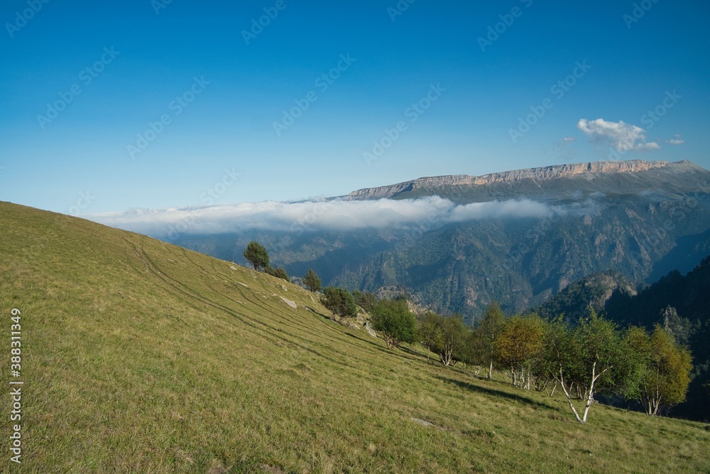 Fototapeta premium soaring clouds against the backdrop of the mountain