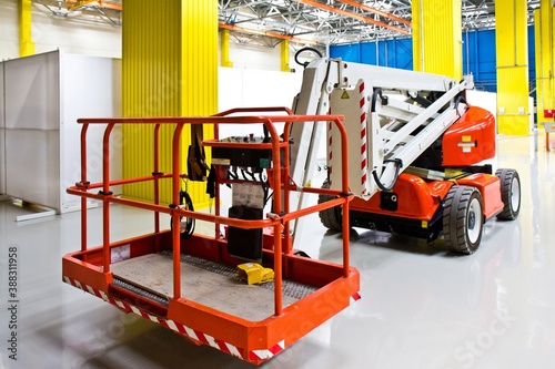 New self propelled lifting platform inside an empty assembly hall.