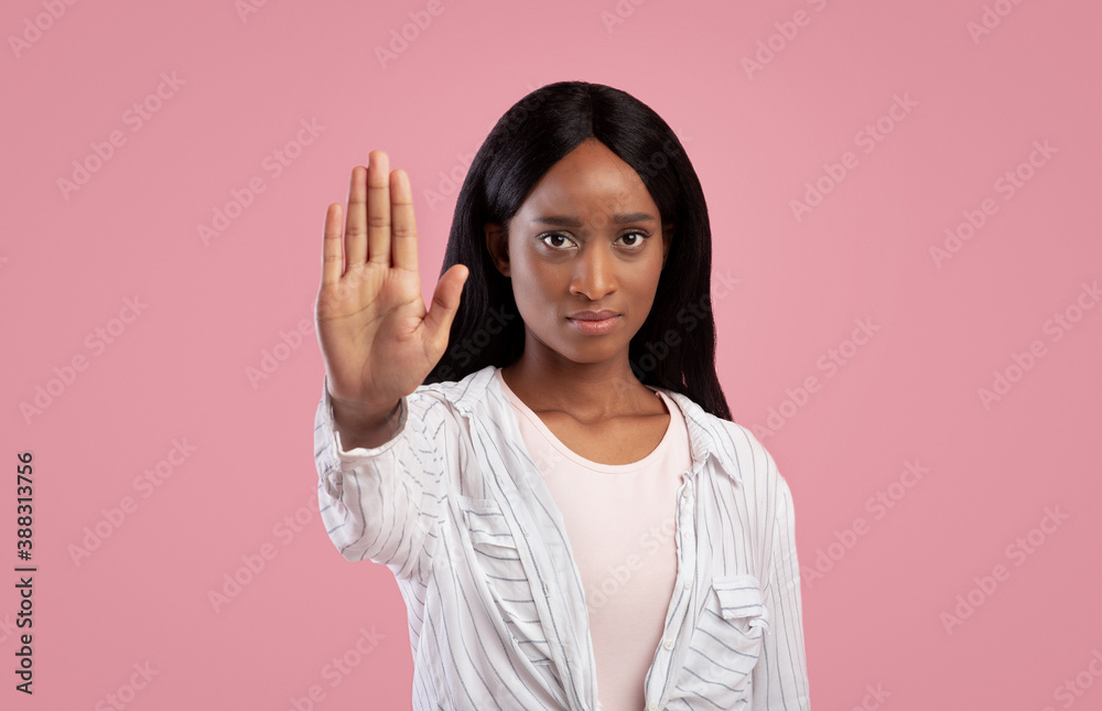 Thank you but no concept. Serious black woman making stop gesture on pink studio background Thank you but no concept. Serious black woman making stop gesture on pink studio background
