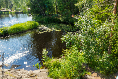 beautiful landscape with waterfall  river  green trees and plants  rocks  mountain in summer in Karelia  Russia