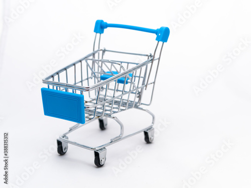Mini empty grocery cart isolated on white background