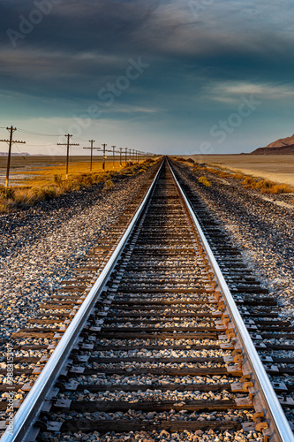 Landscape image of a railroad. Scenic and beautiful. The desert and mountains are nearby.