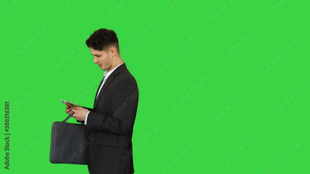 Young business man walking counting euro bills on a Green Screen, Chroma Key. Young business man walking counting euro bills on a Green Screen, Chroma Key.