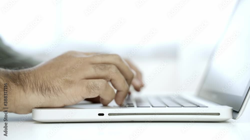 Work from home concept. Close up. Asian male business wear a
suit work at home open laptop and begin to typing his work with finger. 4K Resolution.