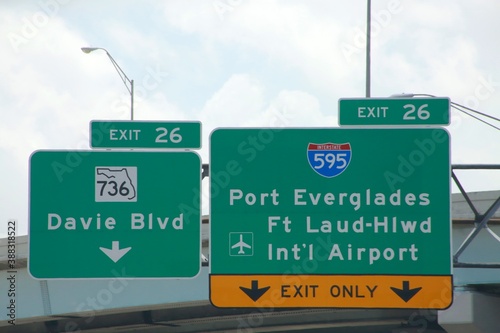 Exit 26 736 Davie Blvd. 595 Port Everglades Ft. Lauderdale-Hollywood International Airport Exit Only Signs Overhanging the Highway at the Overpass photo